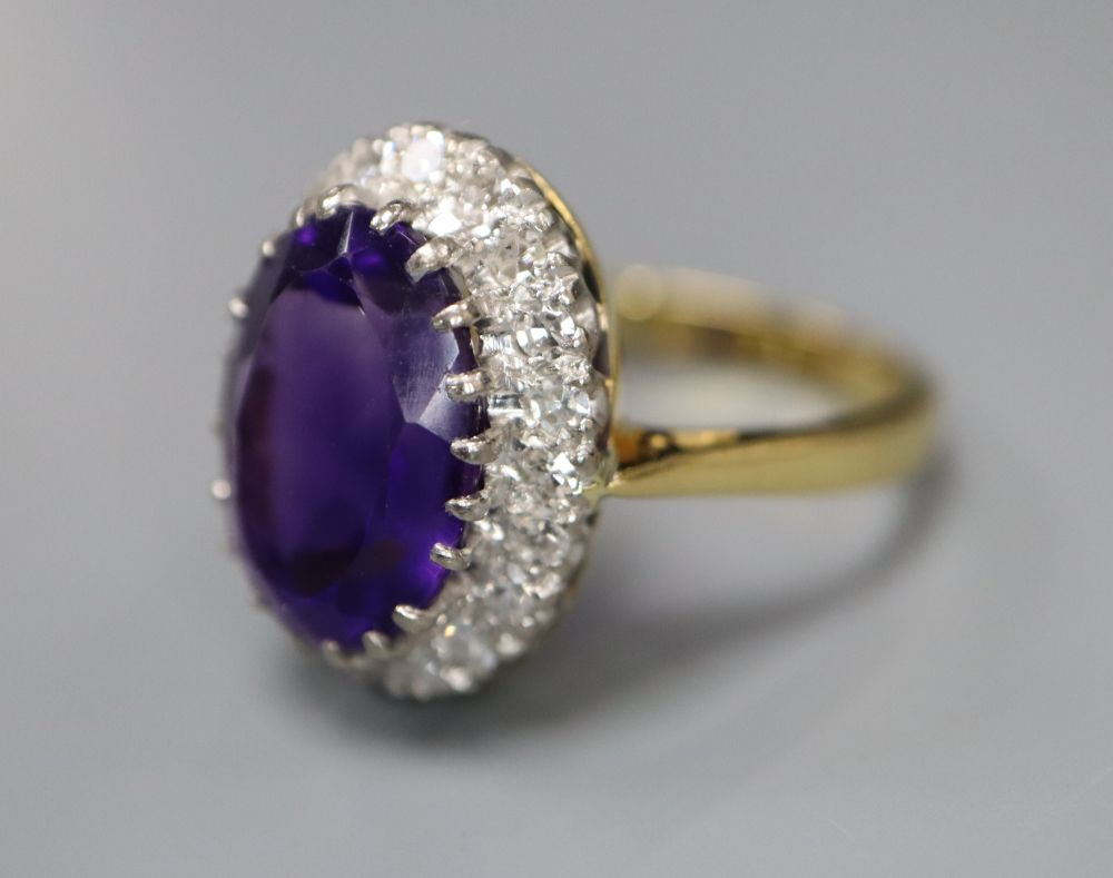 A 1970s 18ct gold, amethyst and diamond set oval cluster dress ring, size Q, gross 7.8 grams.